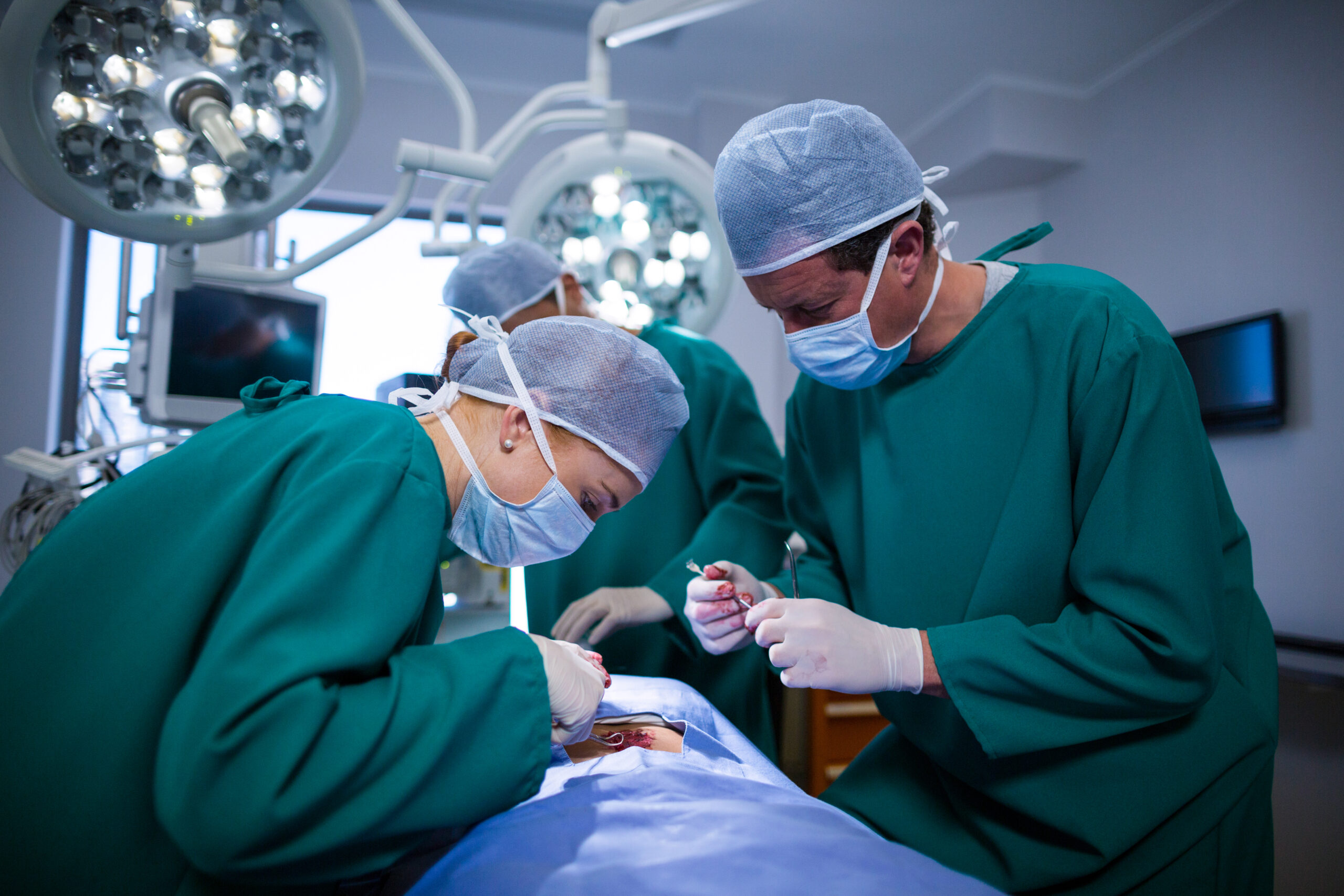 Surgeons performing operation in operation theater of hospital